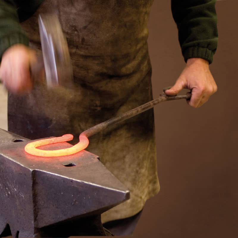 Artigianfer's master blacksmiths while forging iron - Artigianfer Spello Umbria
